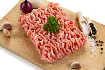 Raw minced pork on cutting board and vegetables 