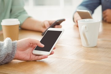 Cropped hands using mobile phones 