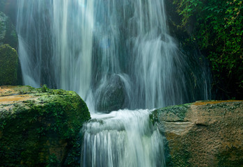 The waterfall from in forest in sunlight