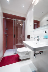 Interior of a small red white bathroom