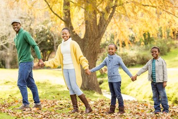 Young smiling family giving their hands to others