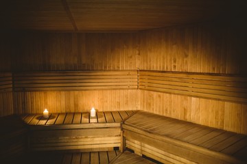 A sauna room with lit candles