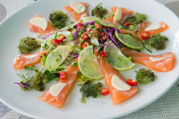 Green Caviar and salmon in spicy salad