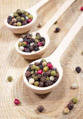 Color pepper on a wooden background.