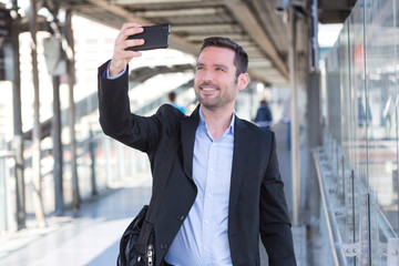 Young attractive businessman taking some selfies