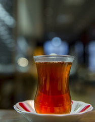 Turkish tea filled traditional glass with selective focus