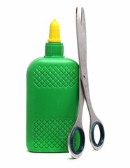 a bottle of glue and scissors on a white background