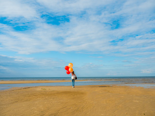 beautiful woman holding balloons