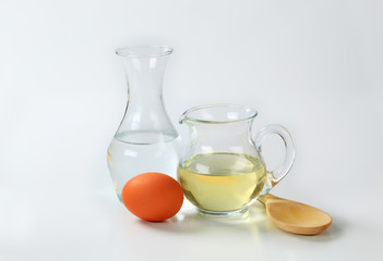 water, oil, egg and wooden spoon