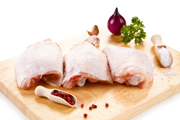 Raw chicken thighs on cutting board