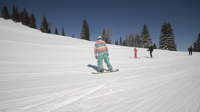 Snowboarder perform tricks