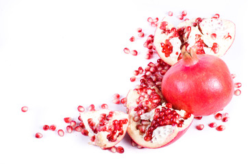 Ripe pomegranate fruit and seeds isolated on white background.
