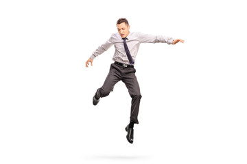 Businessman jumping in the air and looking down