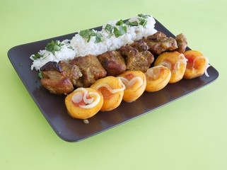 roasted pork meat with rice and peaches