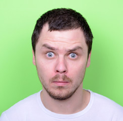 Obraz premium Portrait of man with funny face against green background