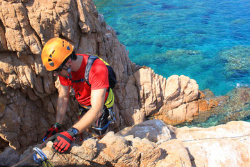 guy working in a via ferratas over the sea