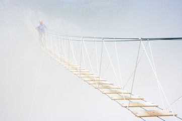 Hanging bridge in fog