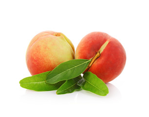 Peach with leaves isolated on white background