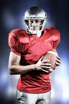 Composite image of  american football player holding ball