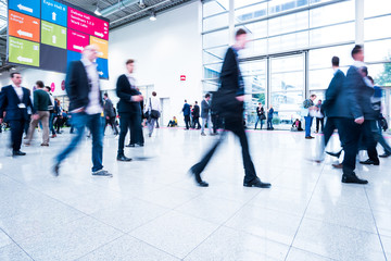 Blurred people using a skywalk/staircase