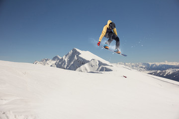 Flying snowboarder on mountains