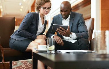 Businesspeople looking at digital tablet