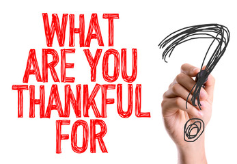 Hand with marker writing: What Are You Thankful For?