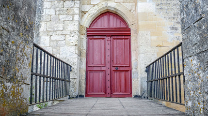 Fototapeta na wymiar Big red medieval door with two black metal railings