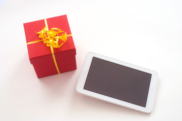 close up of isolated digital Tablet and red christmas gift box -