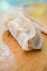 Chinese dumplings or Jiaozi on wooden board
