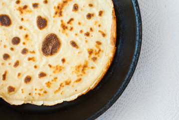 round pancake on white background - from above - studio shot