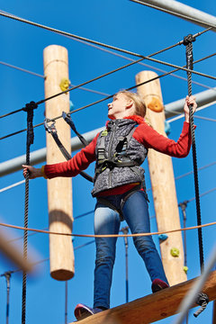 Brave girl is climbing to amusement park