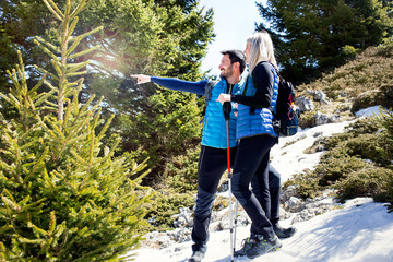 Hiker shows the way in the middle of the mountain