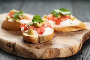 homemade crostini with tomato, mozzarella and olives