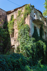 Fototapeta na wymiar Old Abandoned Overgrown European Building