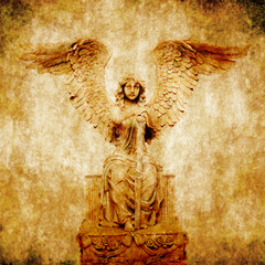 composite of angel statue and grunge background