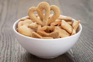 heart cookies for valentines day in white bowl on wood table