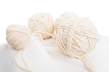Fototapeta na wymiar Balls of soft wool on cotton fabric