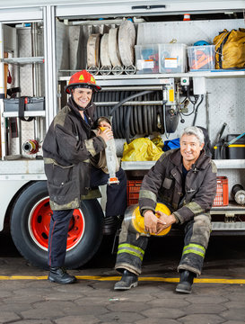 Happy Firefighters By Truck At Fire Station