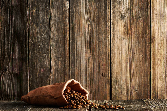 Coffee beans in sack on table