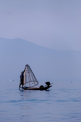 Fisherman at Inle Lake working on one foot