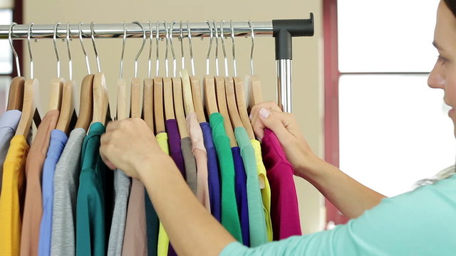 Young woman looking at price tag in clothing store
