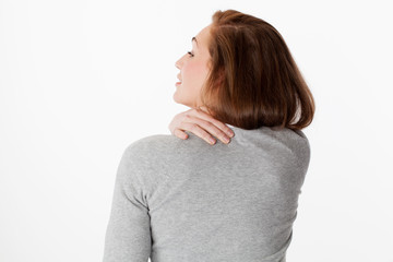 20s woman in back view with shoulders and neck tension