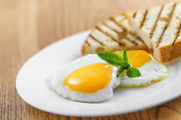 Fried eggs with toasts. Traditional food for breakfast.