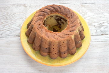 Chocolate and vanilla marble cake on wooden background