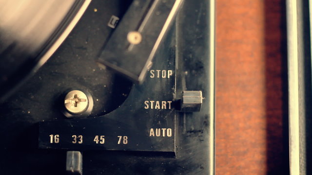 Vintage Record Player. the player is started automatically with the press of a button. camera dollies to the left as needle is placed on. shallow depth of field. vintage feel
