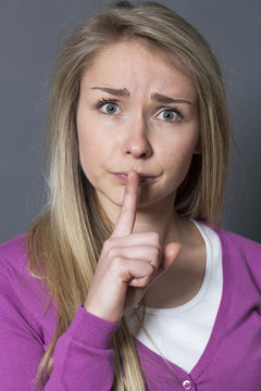 thinking young woman wanting to keep things quiet and confidential