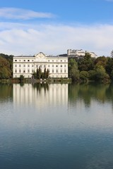 Leopoldskron Palace in Salzburg, Austria, Europe, with fortress Hohensalzburg in the background. The Palace was film location for the Musical Sound of Music with Julie Andrews.