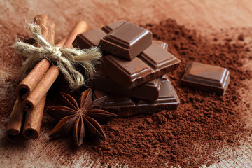 tender milk chocolate and cinnamon with anise on a wooden background