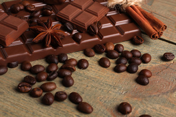 tender milk chocolate and star anise on wooden background